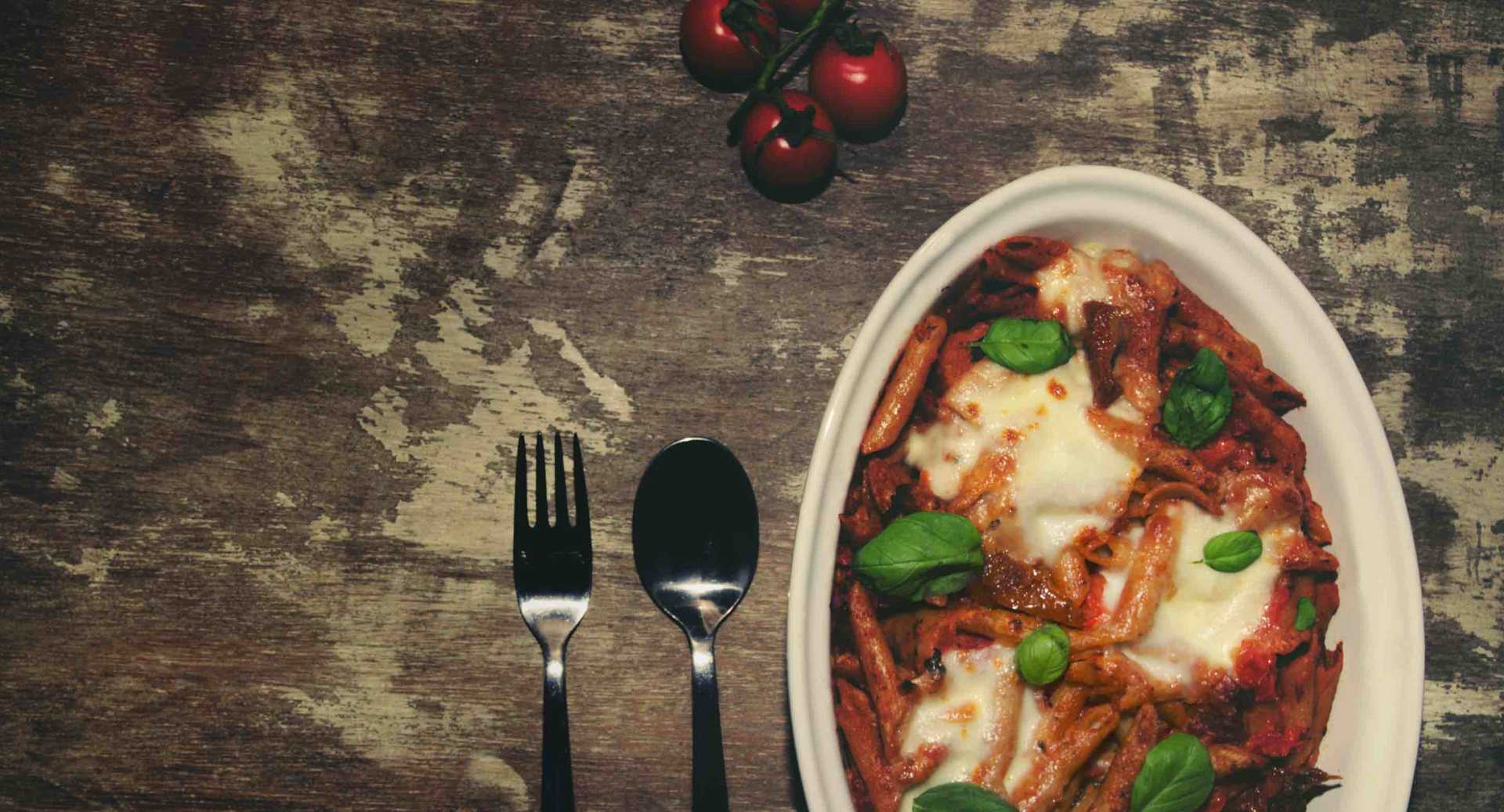 Mouth watering vegetarian pasta bake with rich tomato sauce and cheese toppings